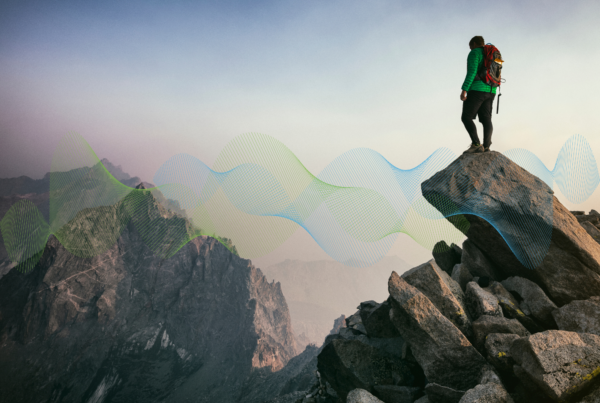 Person standing on a rocky mountain peak, looking at the horizon, with abstract blue and green wave graphics symbolizing career growth and people ecosystems.